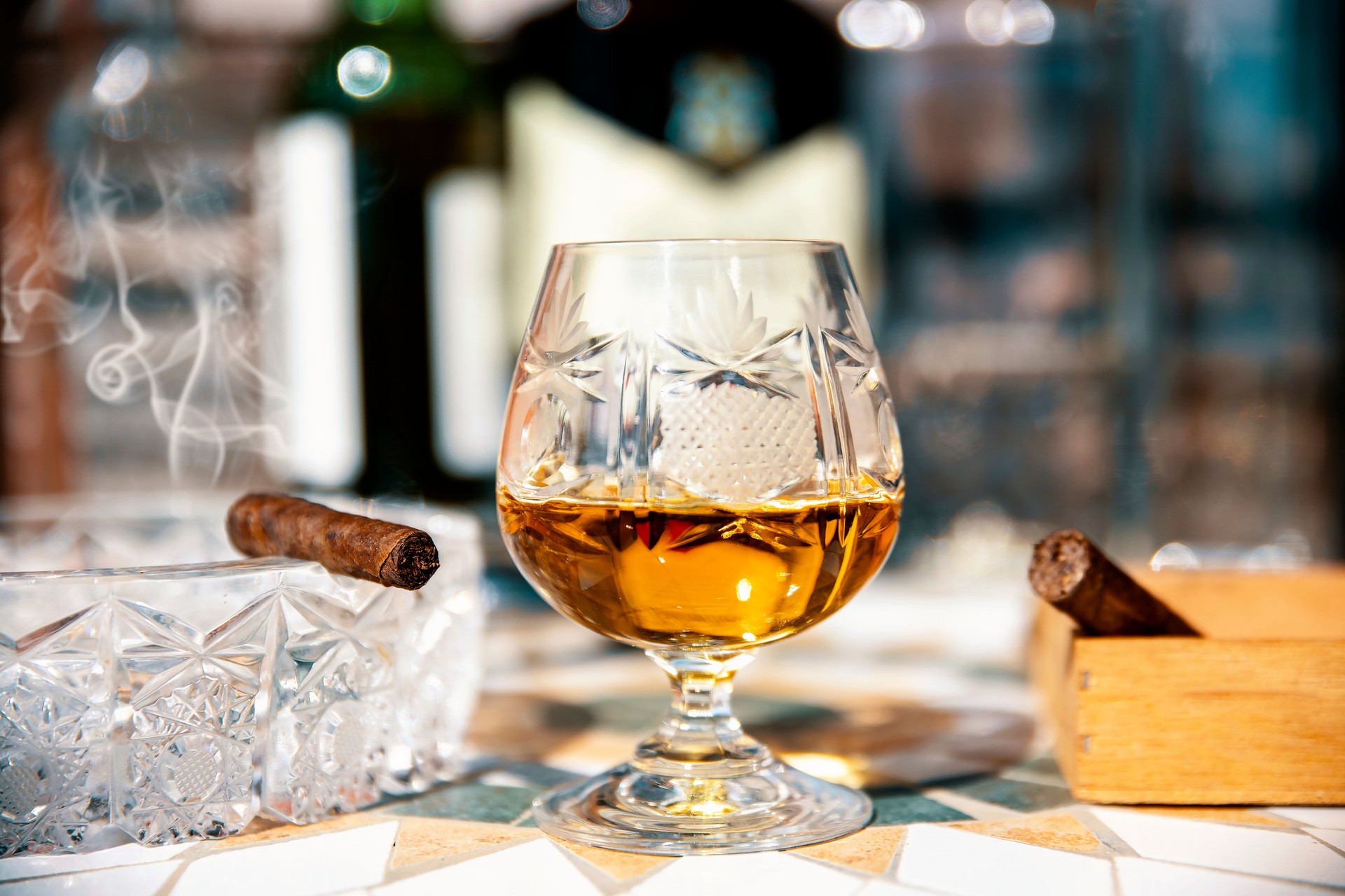 Cuban rum in crystal glass and thabanos cigar